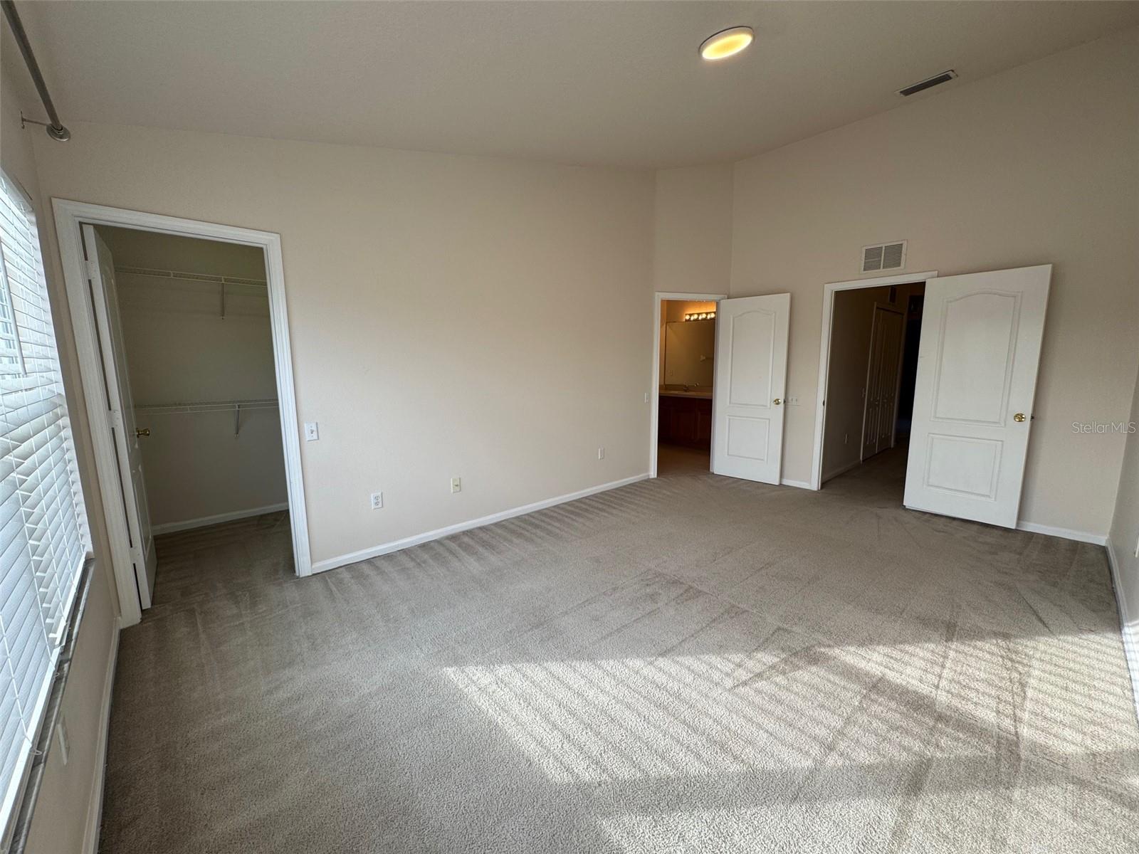 Primary bedroom with huge walk-in closet & en-suite bathroom.