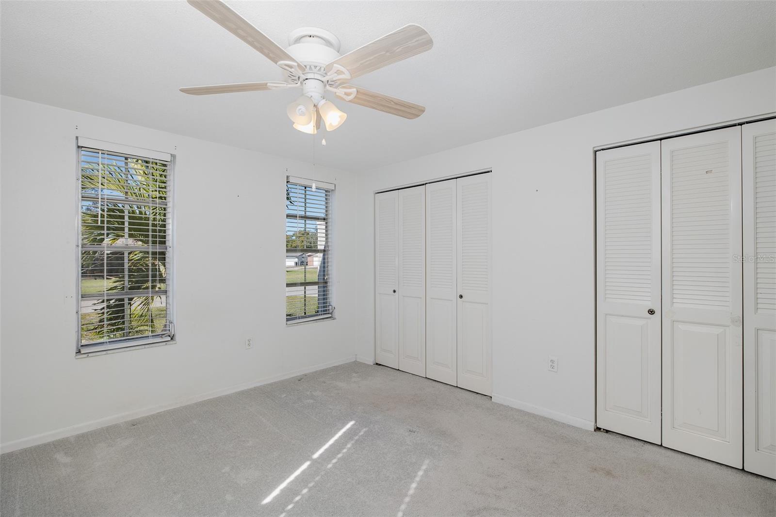 Primary bedroom features dual closets