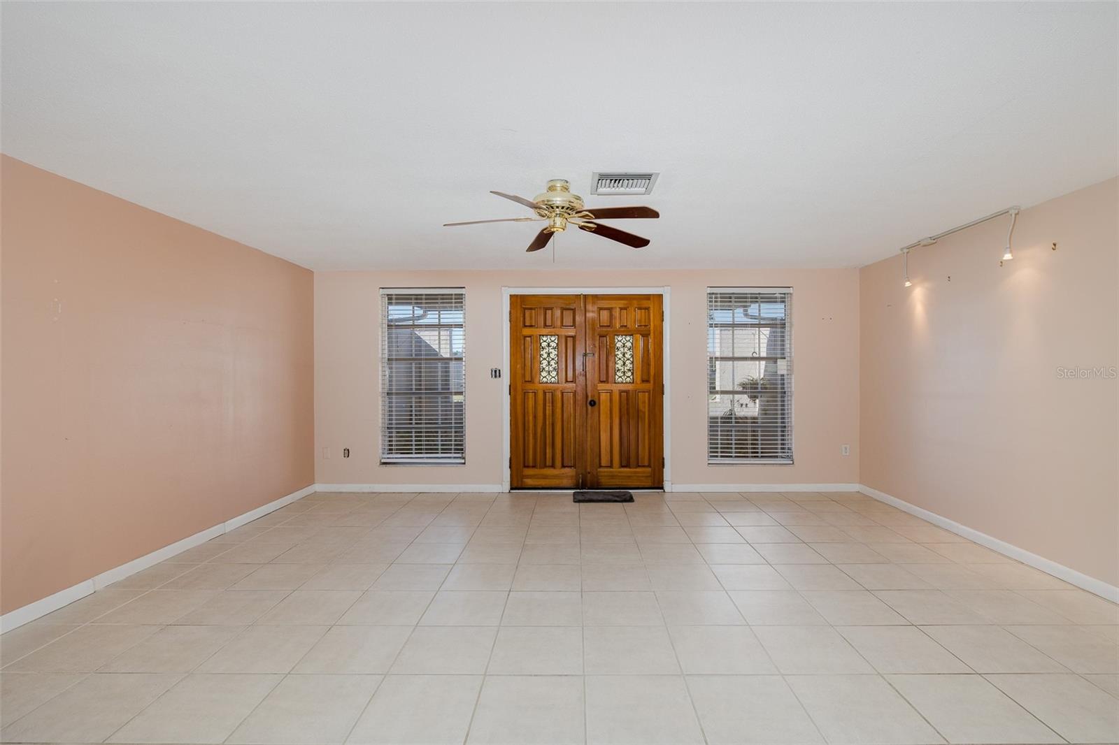 Double front doors welcome you into the living room