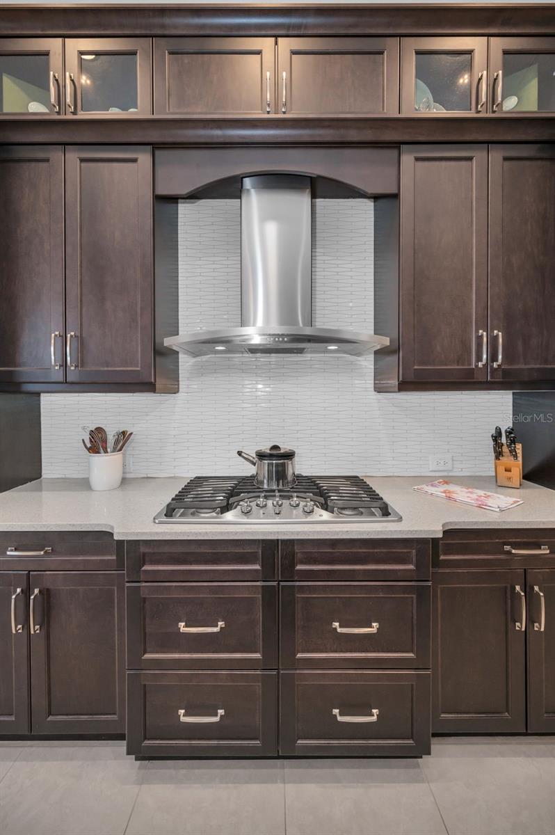 Gas cooktop with glass front display cabinets