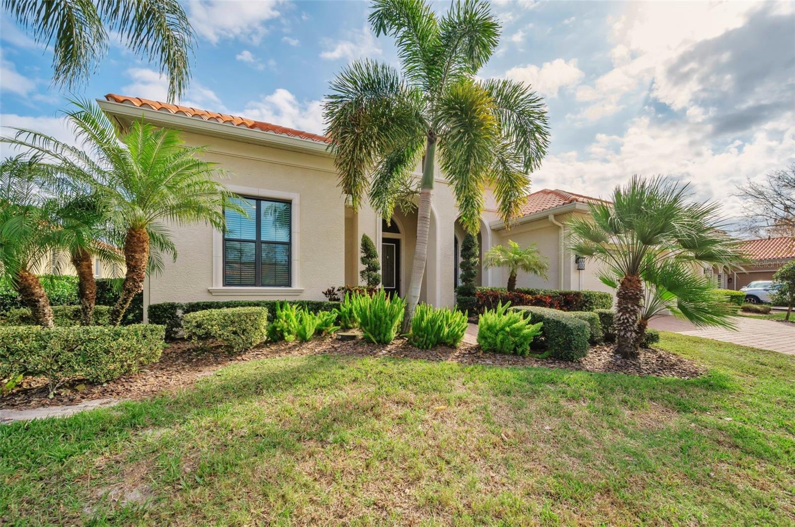 Front view with lush tropical landscaping