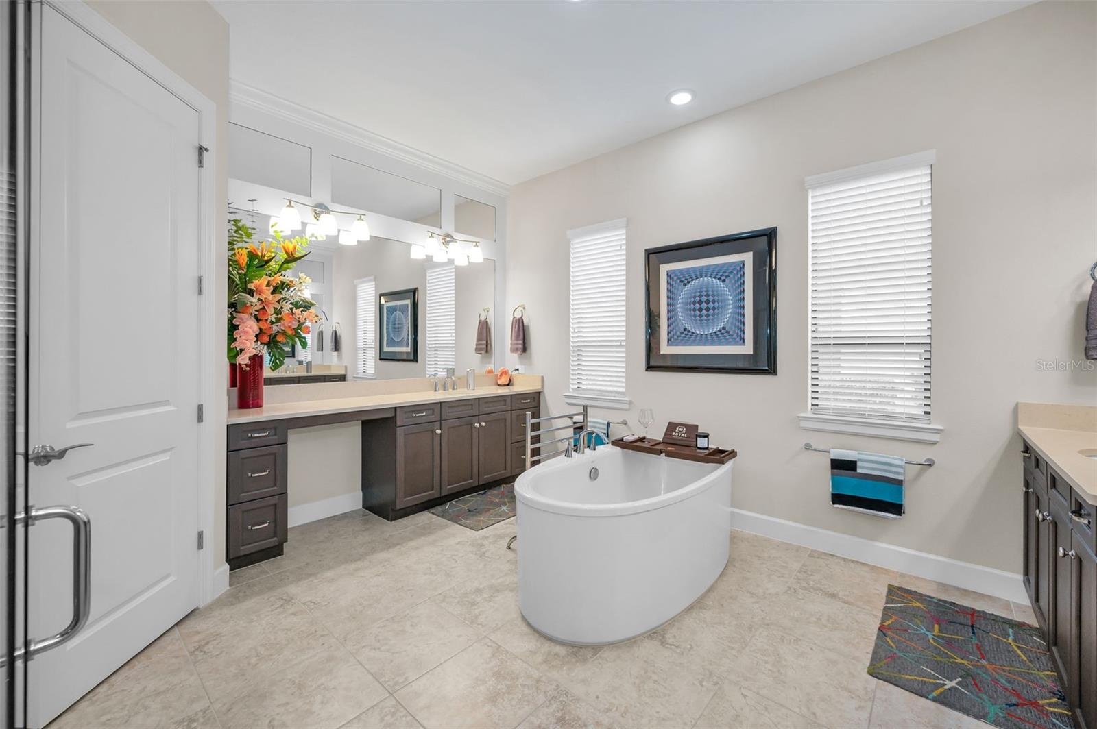 Primary bathroom offers dual vanities with quartz countertops
