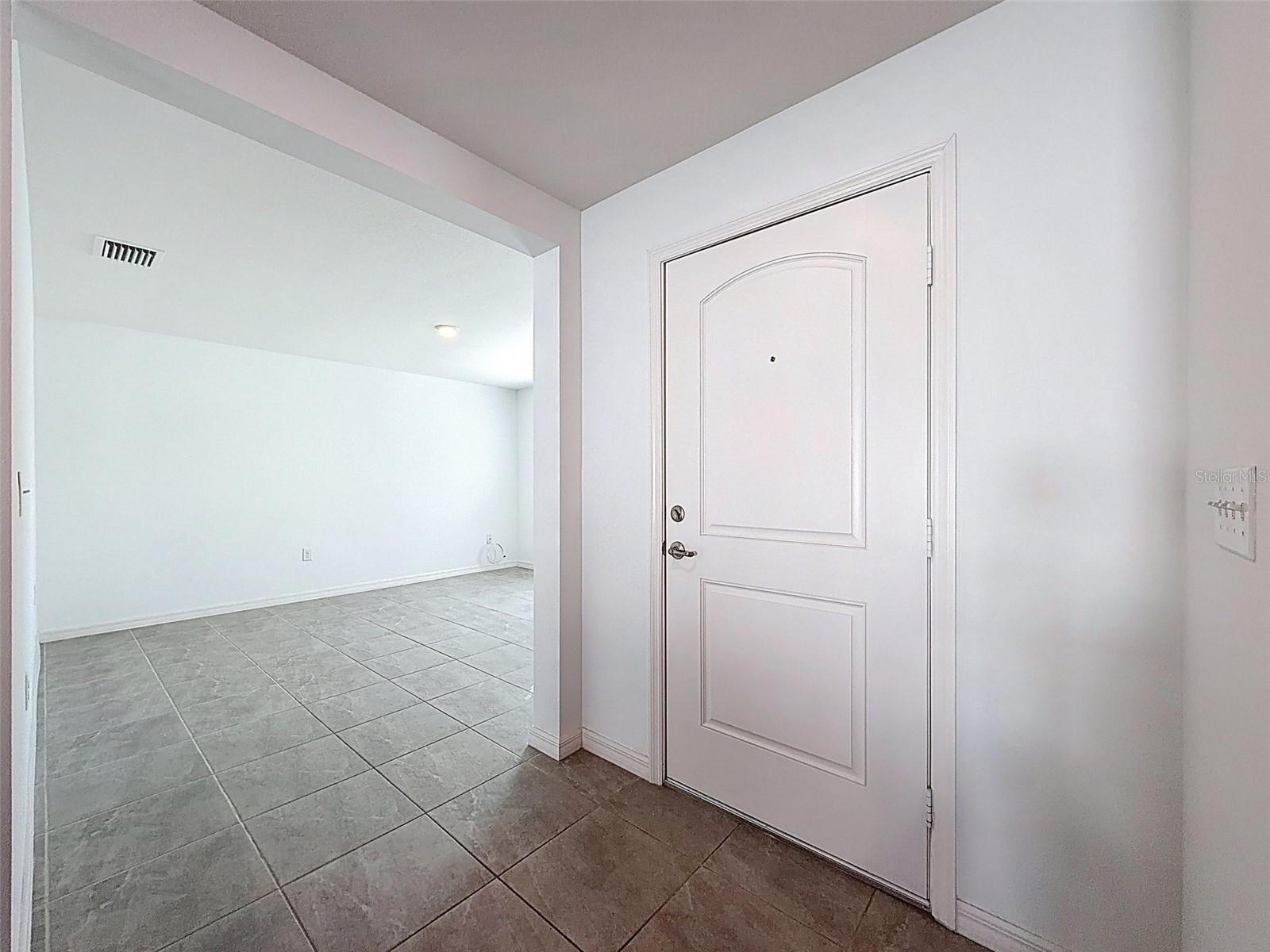 INTERIOR OF THE FRONT DOOR LOOKING INTO DINING ROOM.