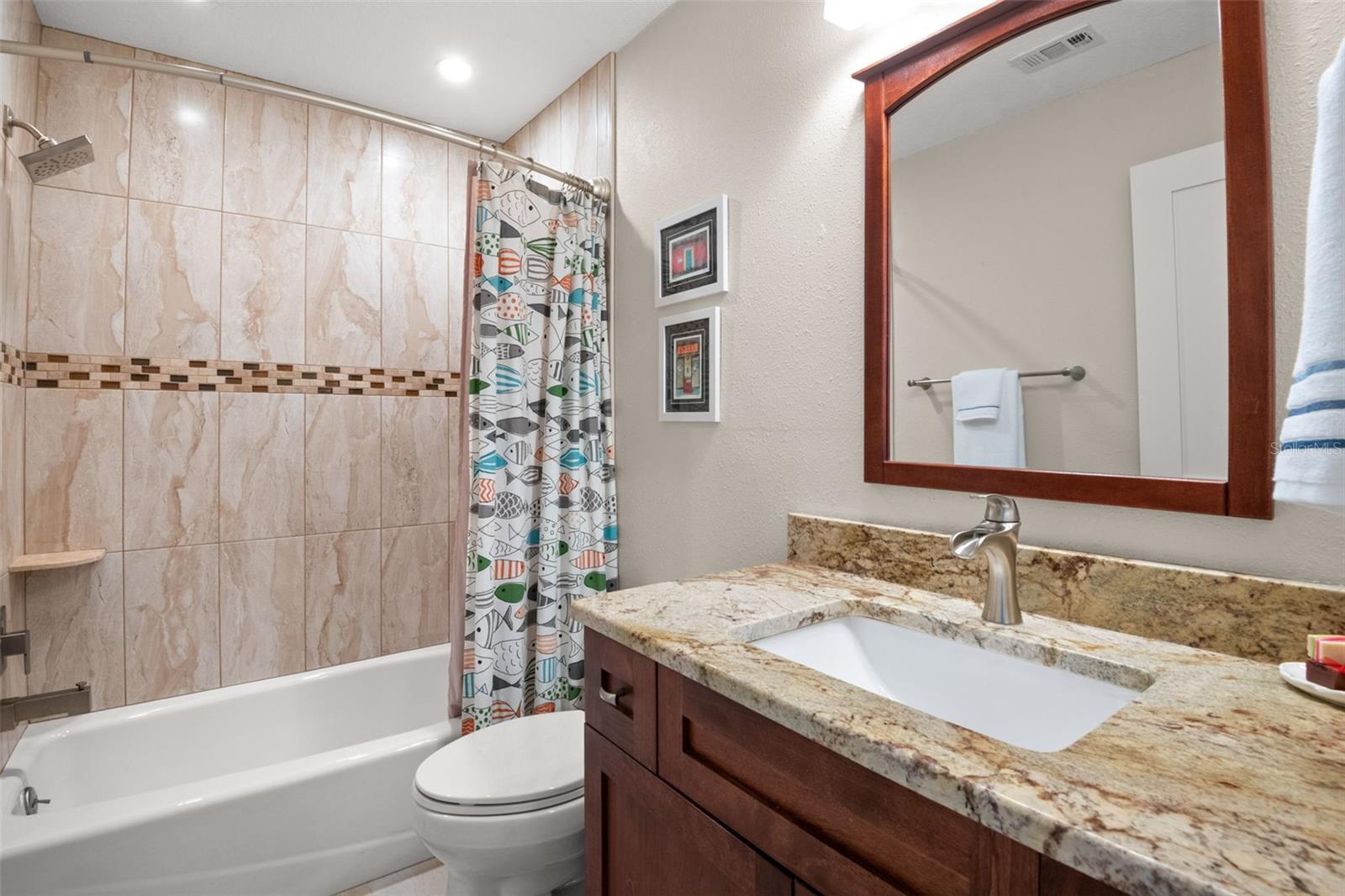 Ensuite bath in second bedroom with tub/shower combination