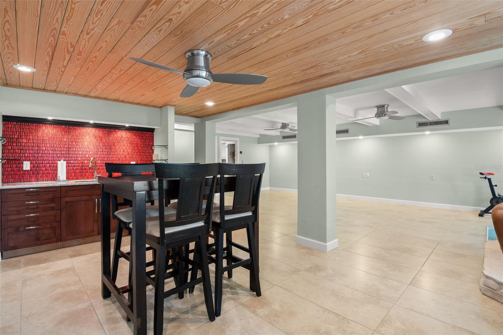 Wet bar area with sink and mini-fridge