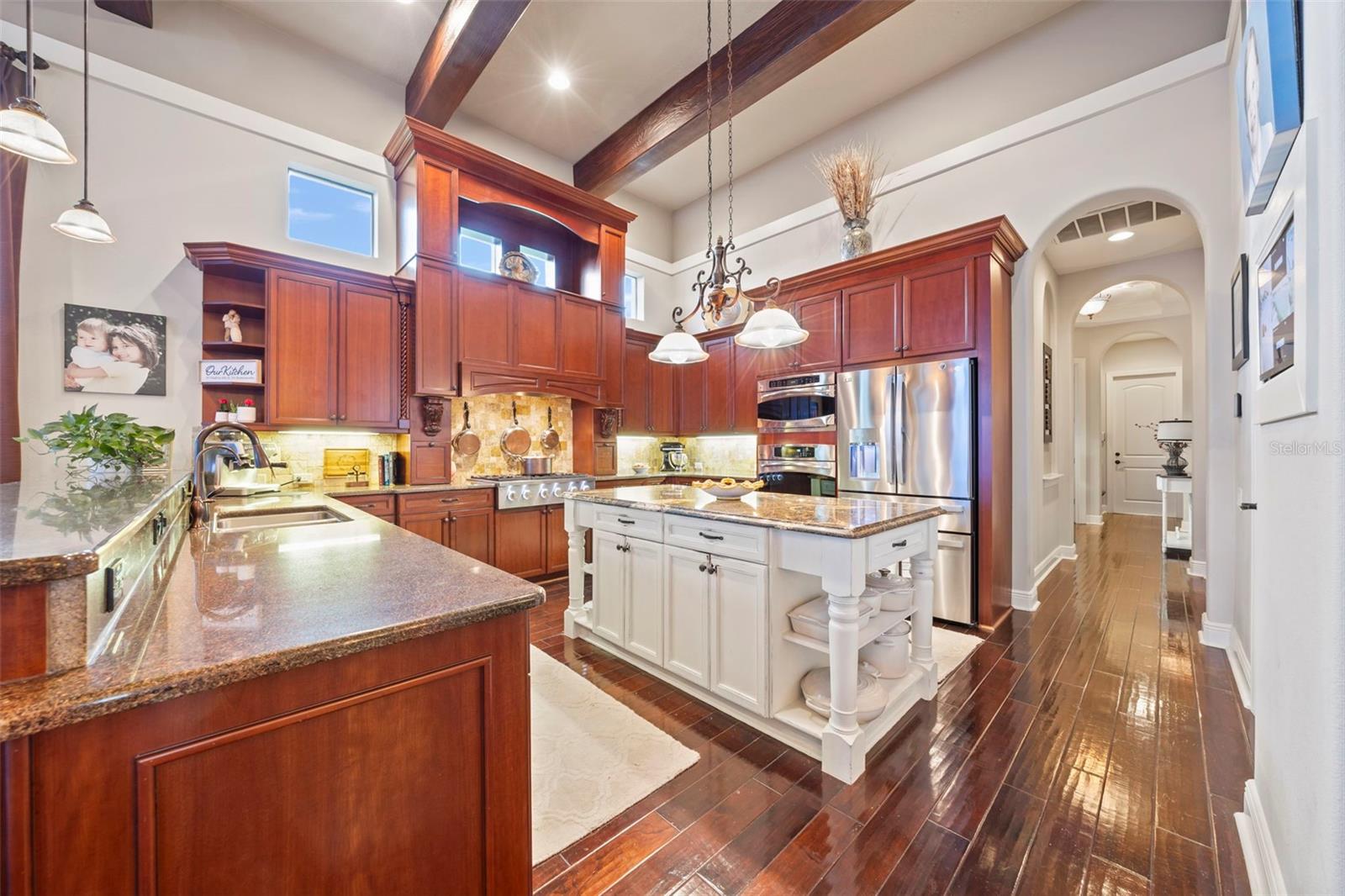 Chef's kitchen with gas cooking and ample storage and counter space