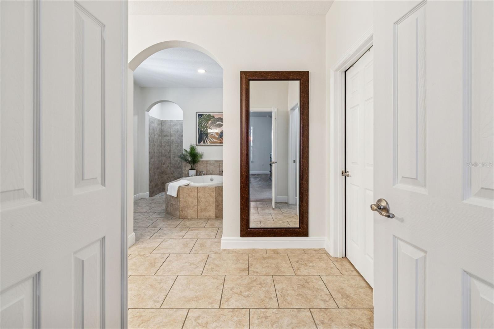 French doors opening into the primary bath