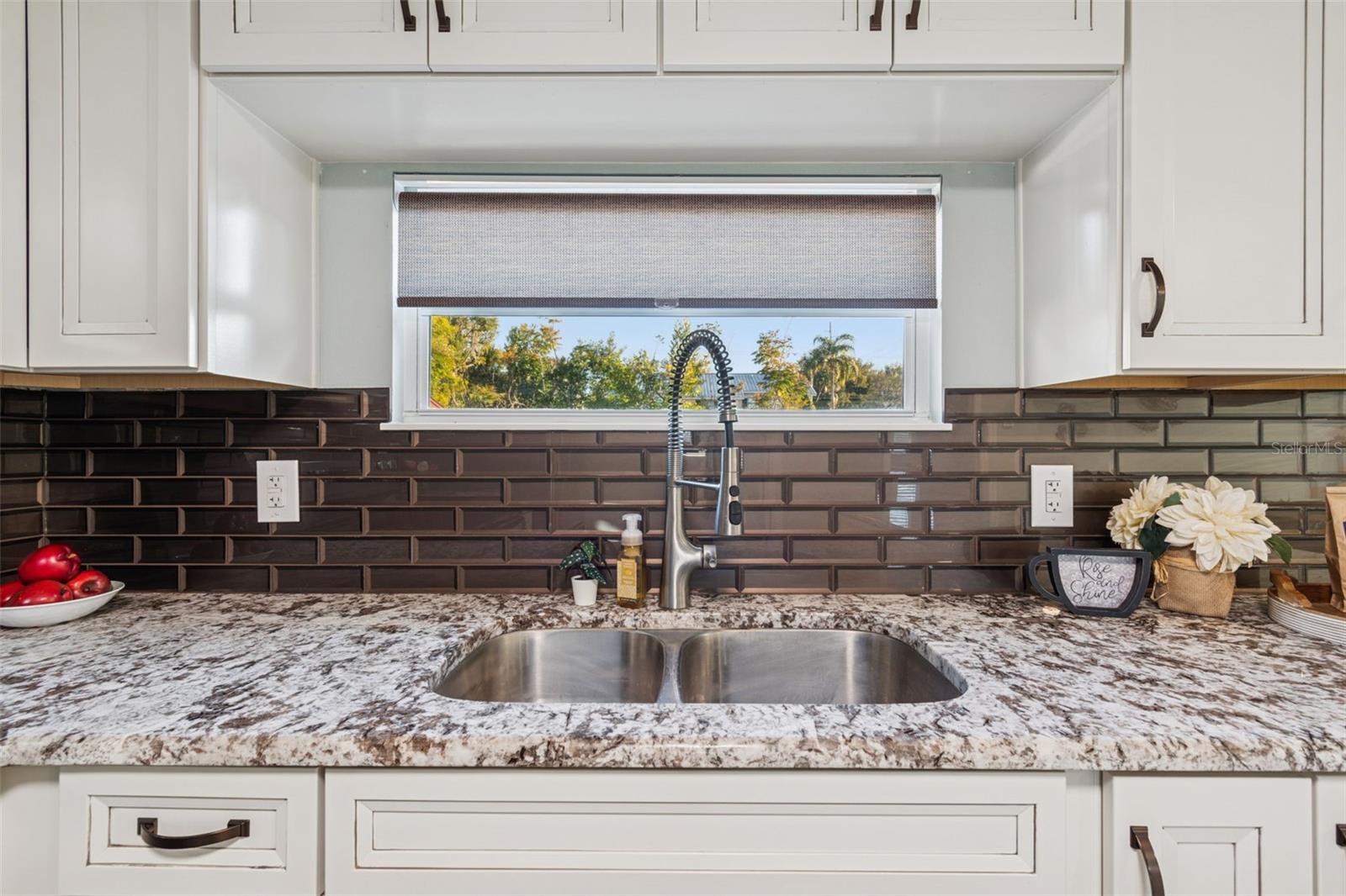 Deep stainless sink with double basin and luxury sink fixture.