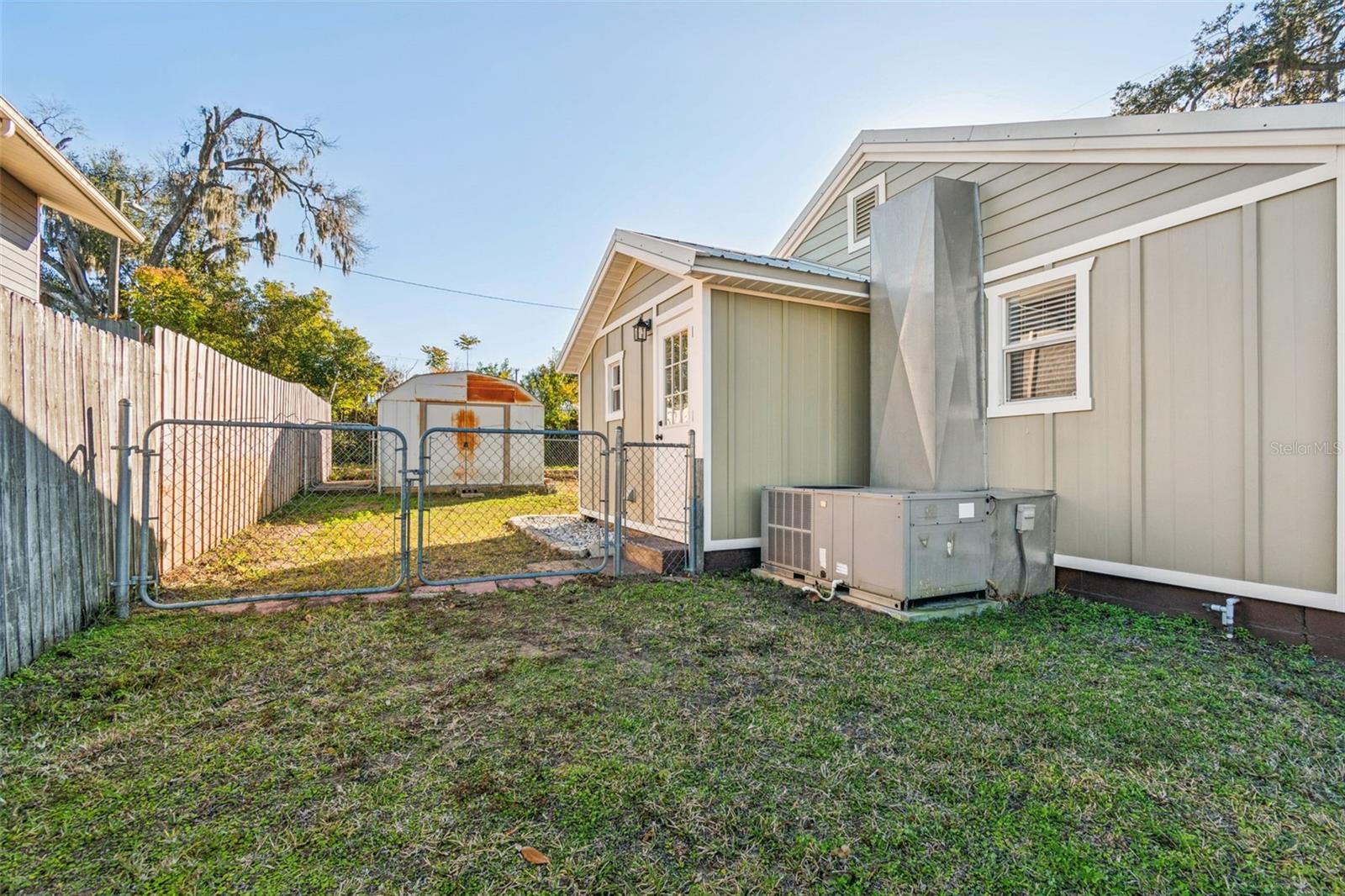 Fenced side yard w/ drive gate.