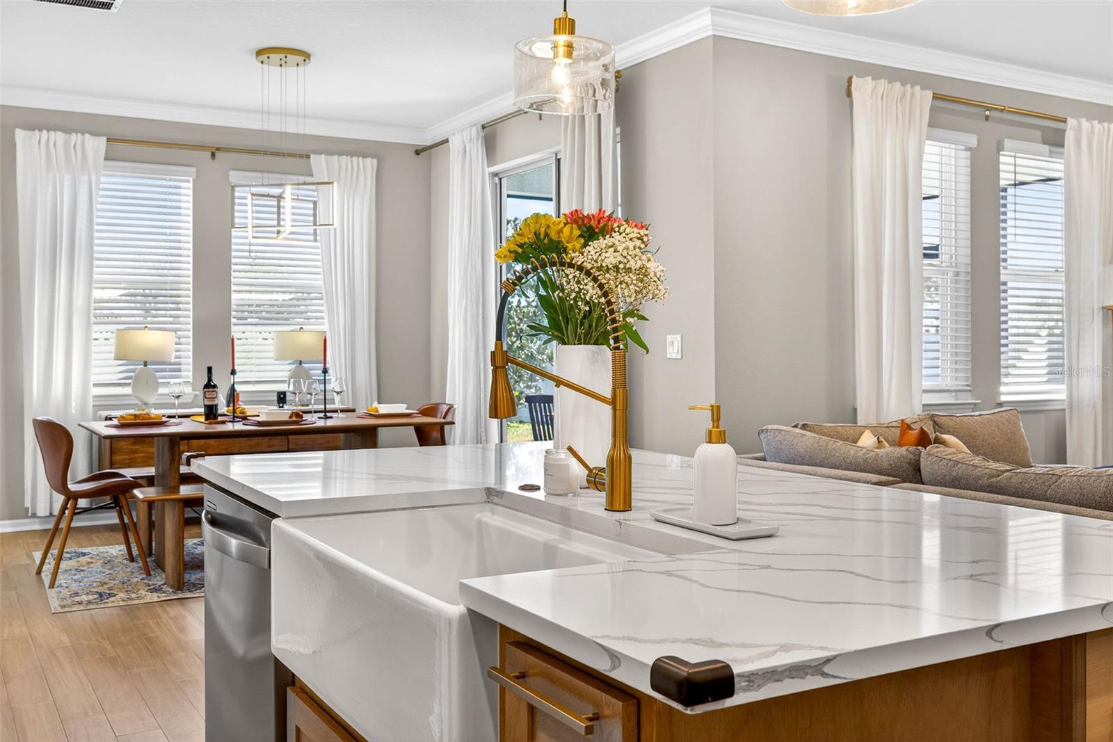 A farmhouse sink adorns the center of the island.