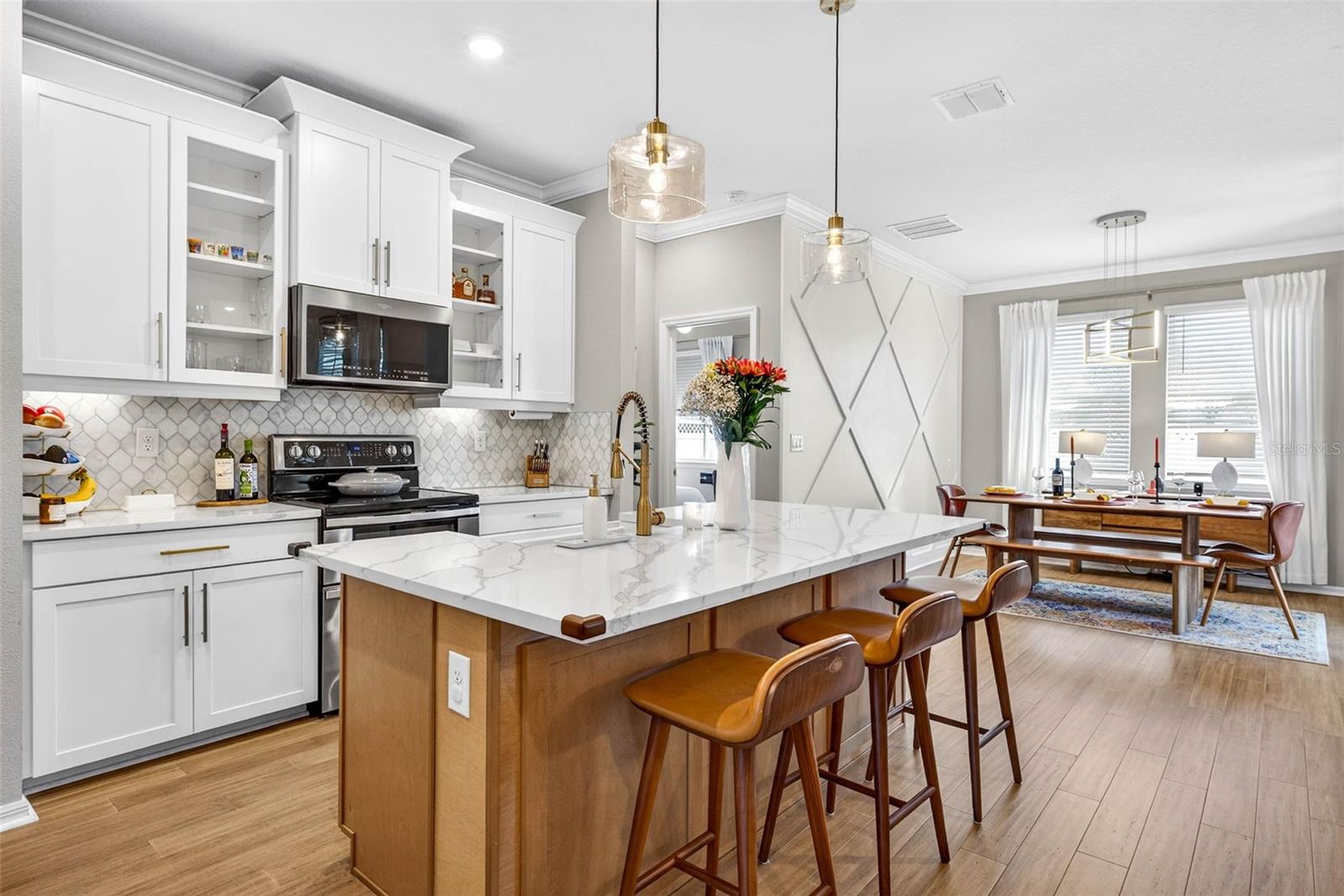 The kitchen has a completely remodeled island, upgraded sink/cabinetry/crown/light fixtures.