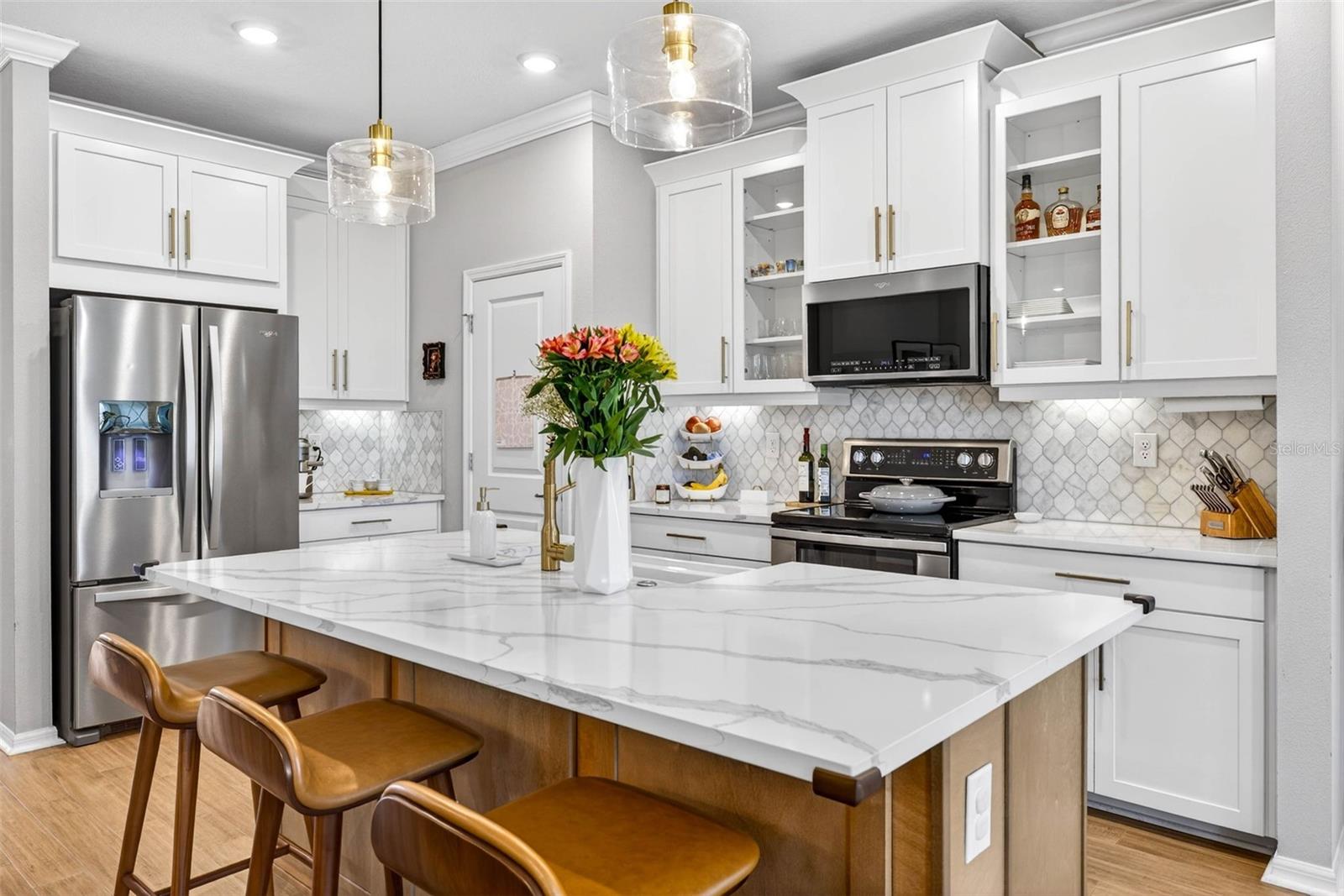 Stunning countertops, stainless steel appliances & seating for 3 at the island.