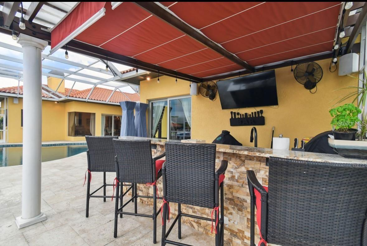 outdoor kitchen with seating area