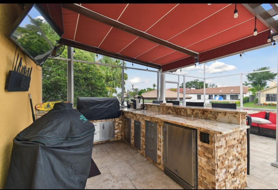 outdoor kitchen with seating area