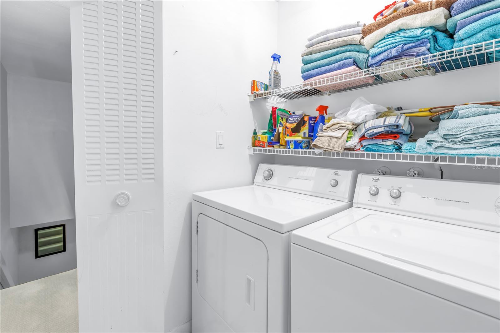 laundry closet located between the two bedrooms in the hall