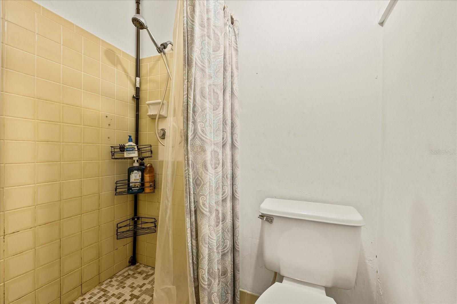 half bath in garage with shower and toilet