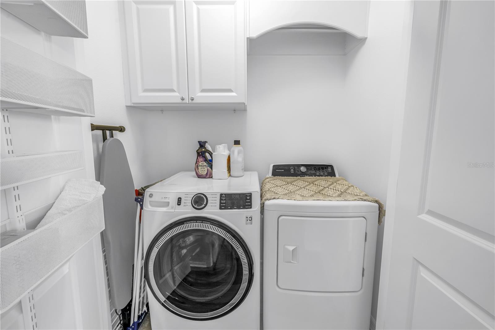 Upstairs laundry closet with storage