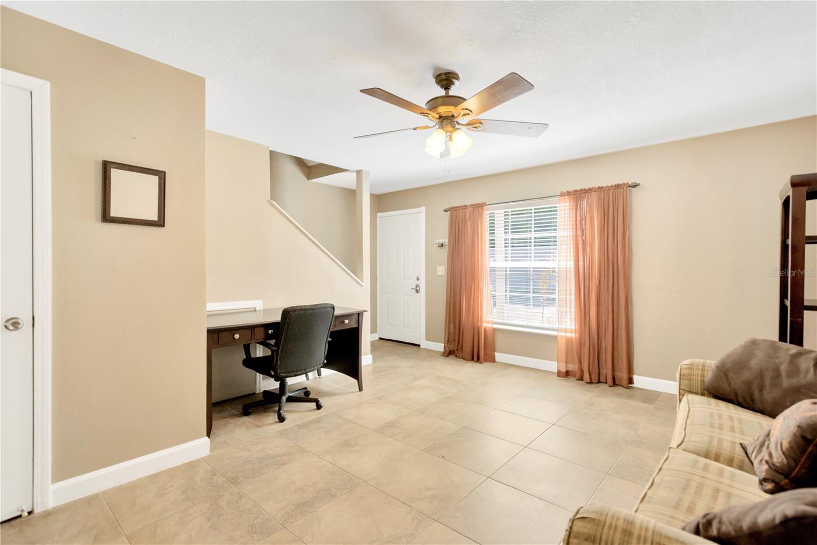 Front room living area has space for a desk, love seat or other piece of decorative furniture.  Half bath (powder room) is also a welcome addition so guests do not have to go to second level.