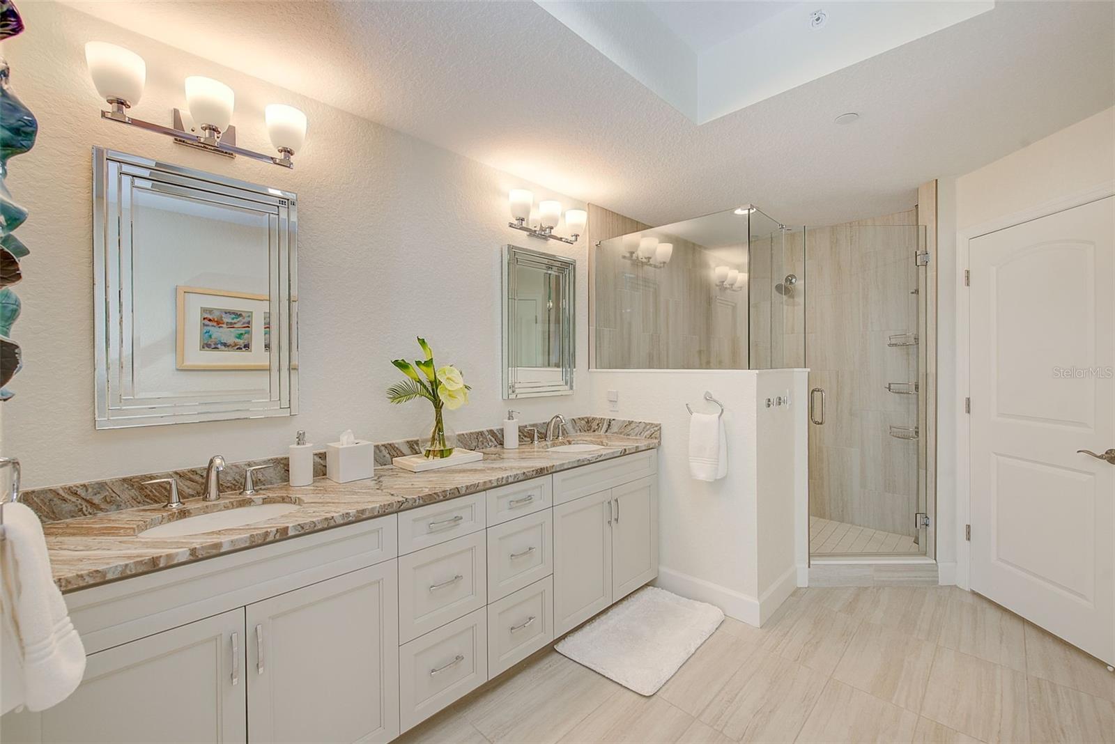 Primary bathroom with dual sinks, large shower and water closet.