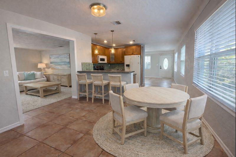 The dining area offers an open, inviting space with seamless flow from the kitchen. (Photo has been virtually staged to illustrate potential use of the space).