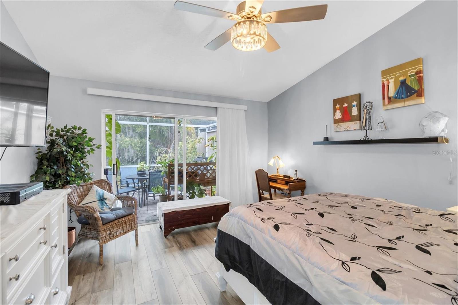 PRIMARY BEDROOM W/ SLIDER AND VIEW OF THE PRESERVE