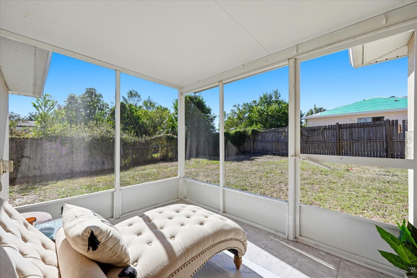 Screened-in patio and fenced yard