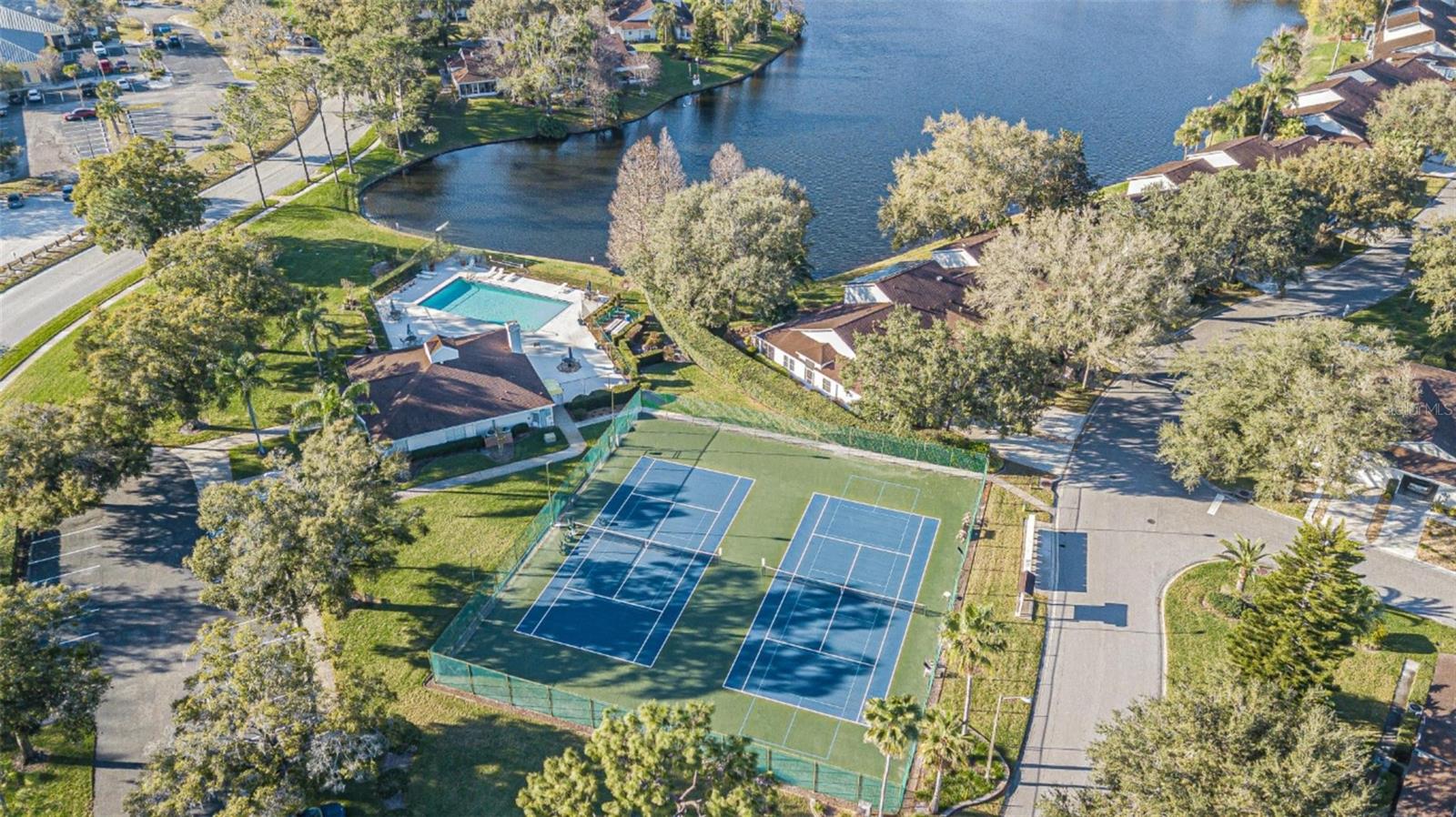 Pickleball/tennis courts and lake.