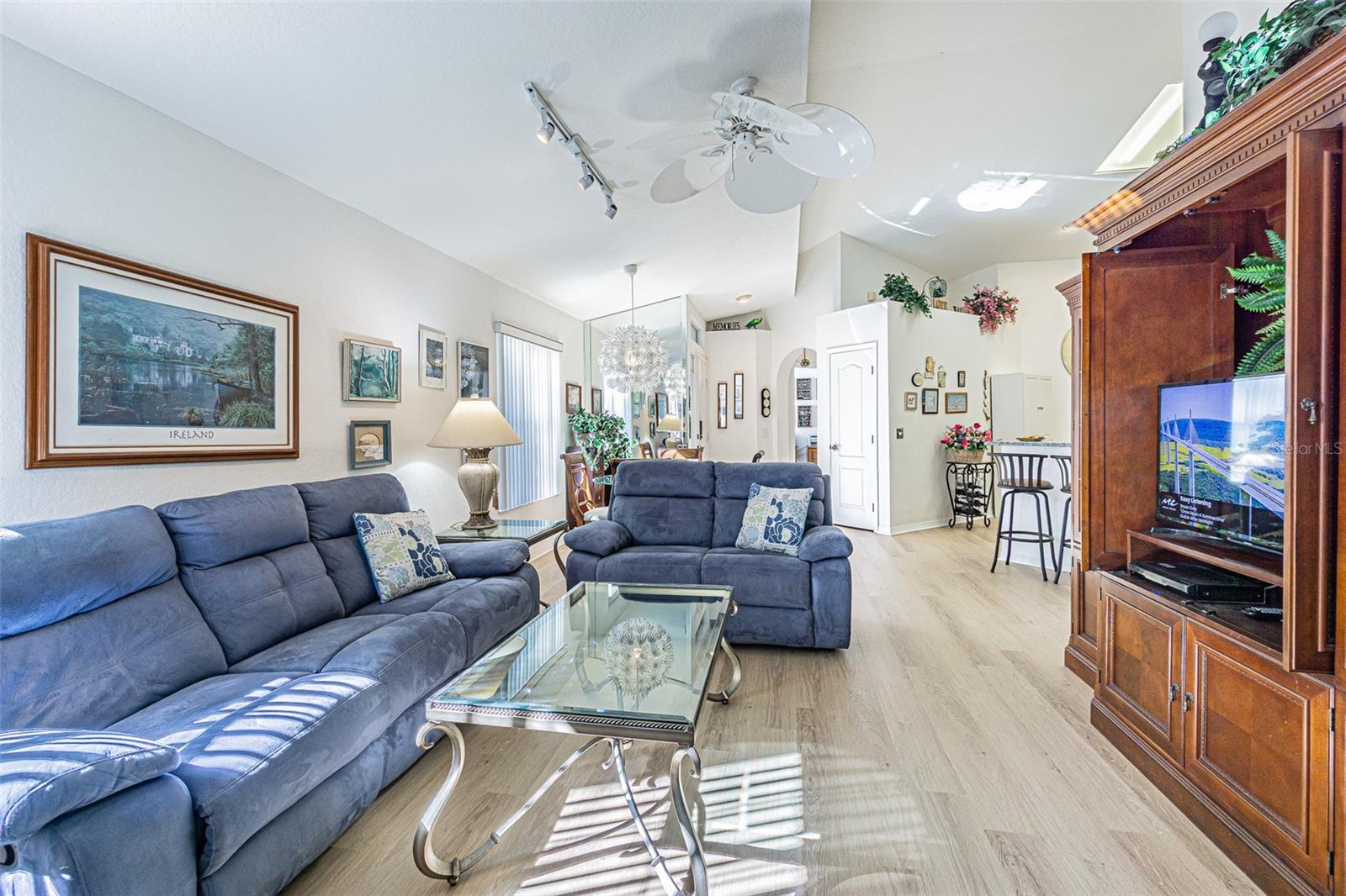 Living room looking back towards the dining room, front entry and hallway to bedrooms 1 and 2.