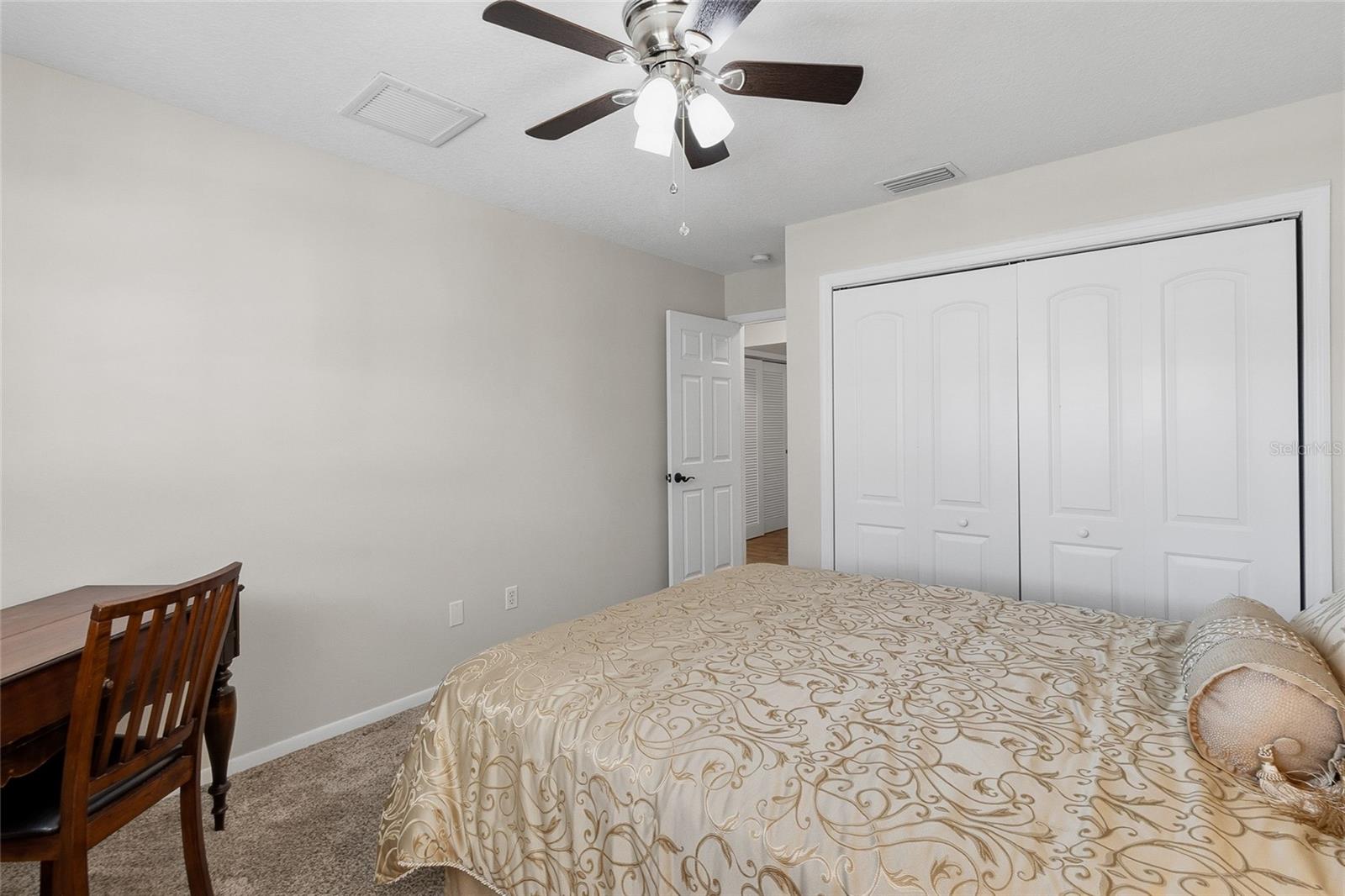Bedroom 2 looking toward spacious closet and hallway.