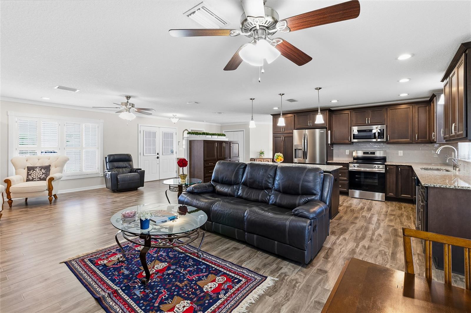 Great room, kitchen area looking toward the front door.