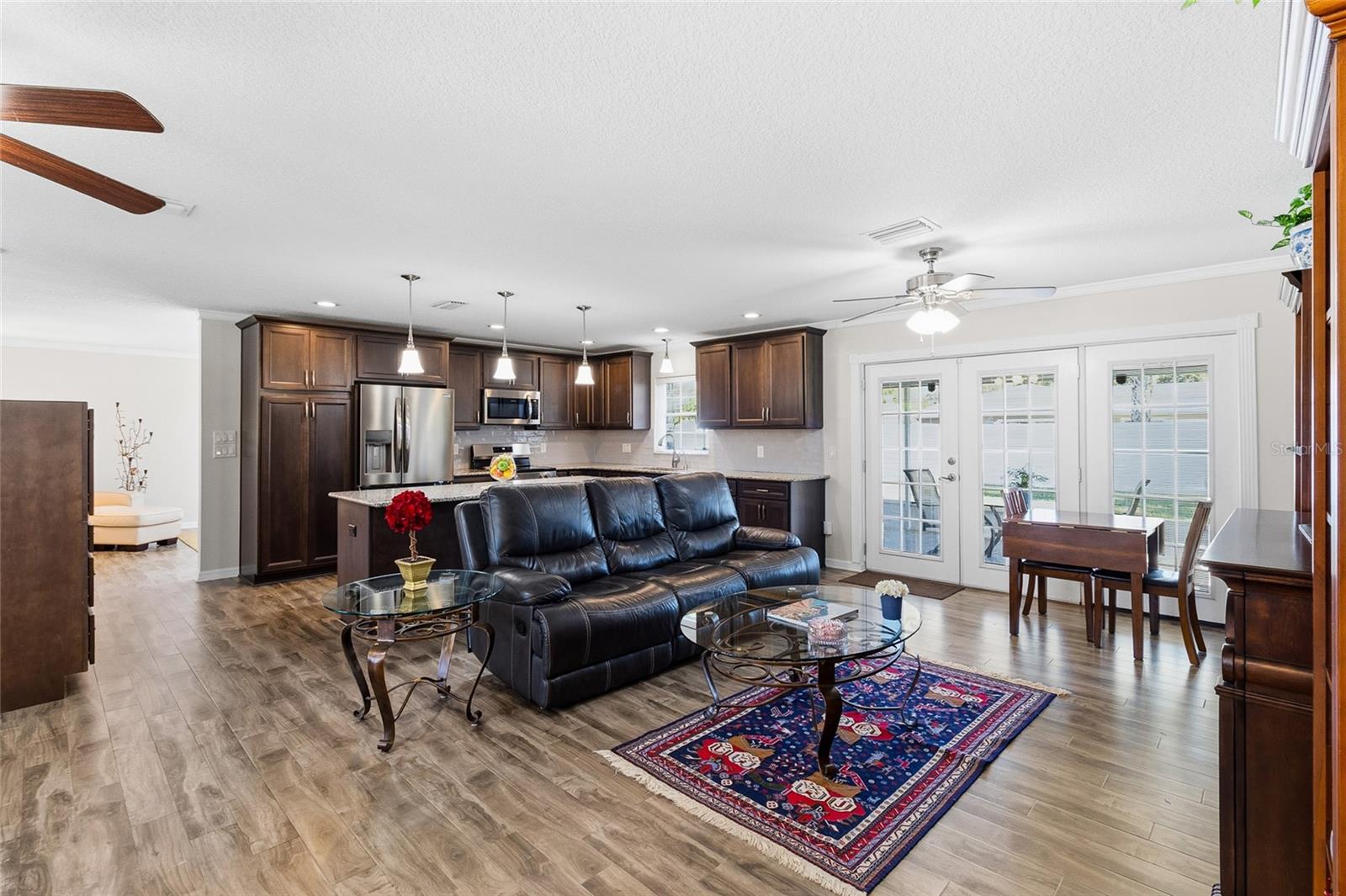 Great room area looking toward kitchen, and french doors leading to the porch area.