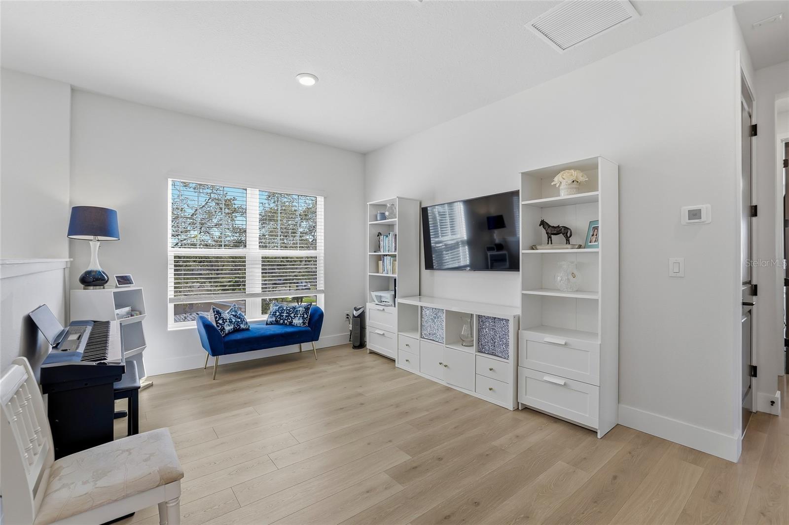 Open and airy bonus room at the crest of the staircase on the second level.