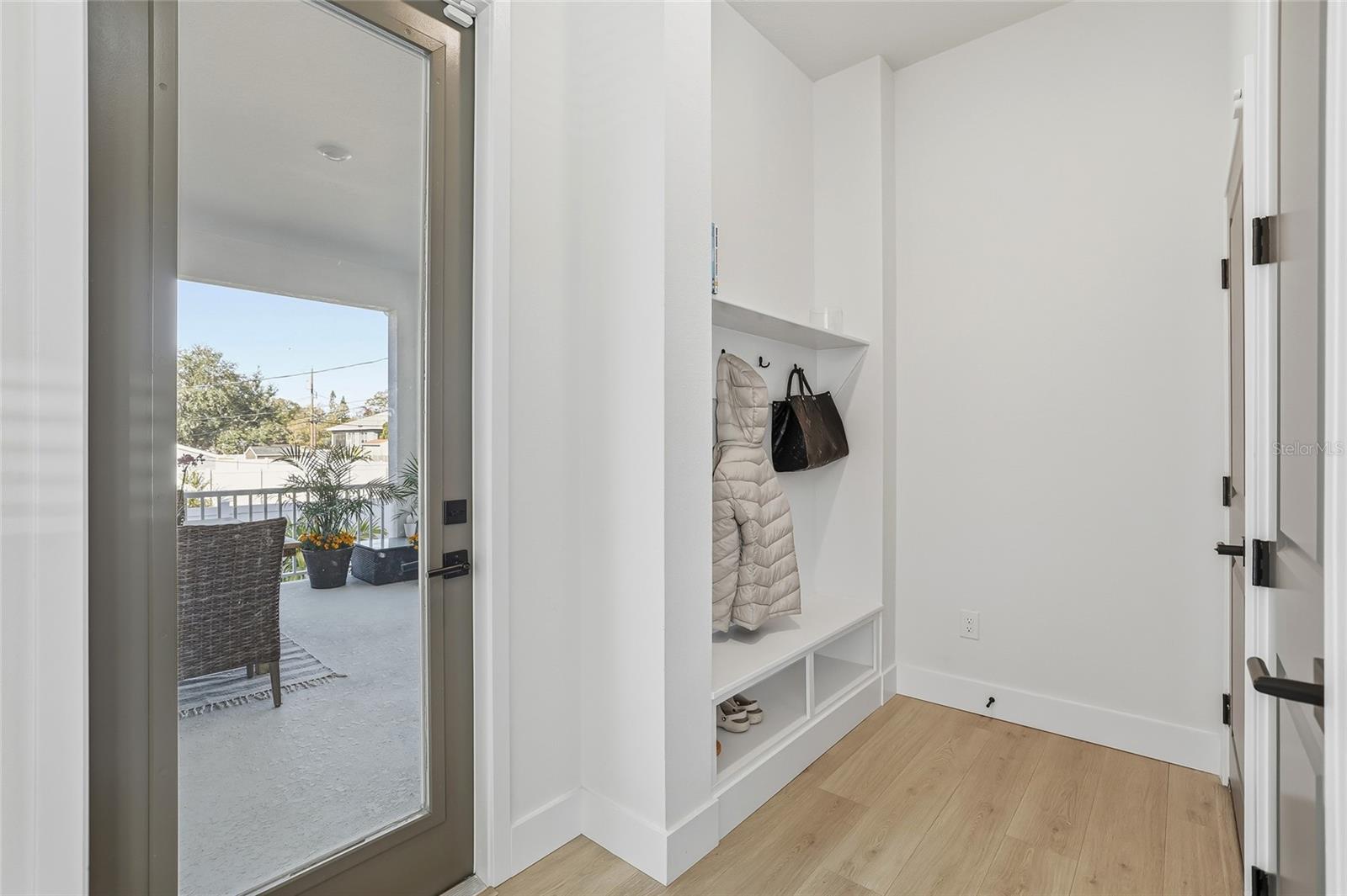Catch-all mud room in between the outdoor patio and attached 2-car garage.