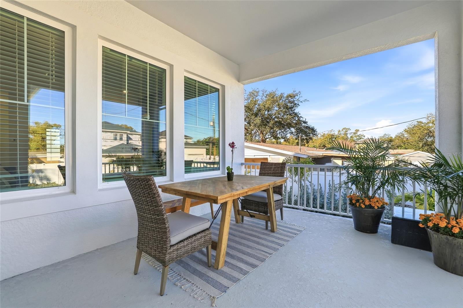 Lovely covered rear porch for alfresco dinners.