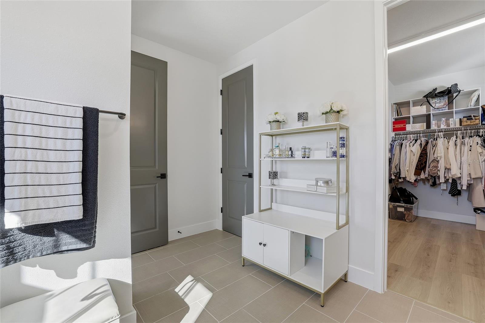 Separate commode to the left with its own door.