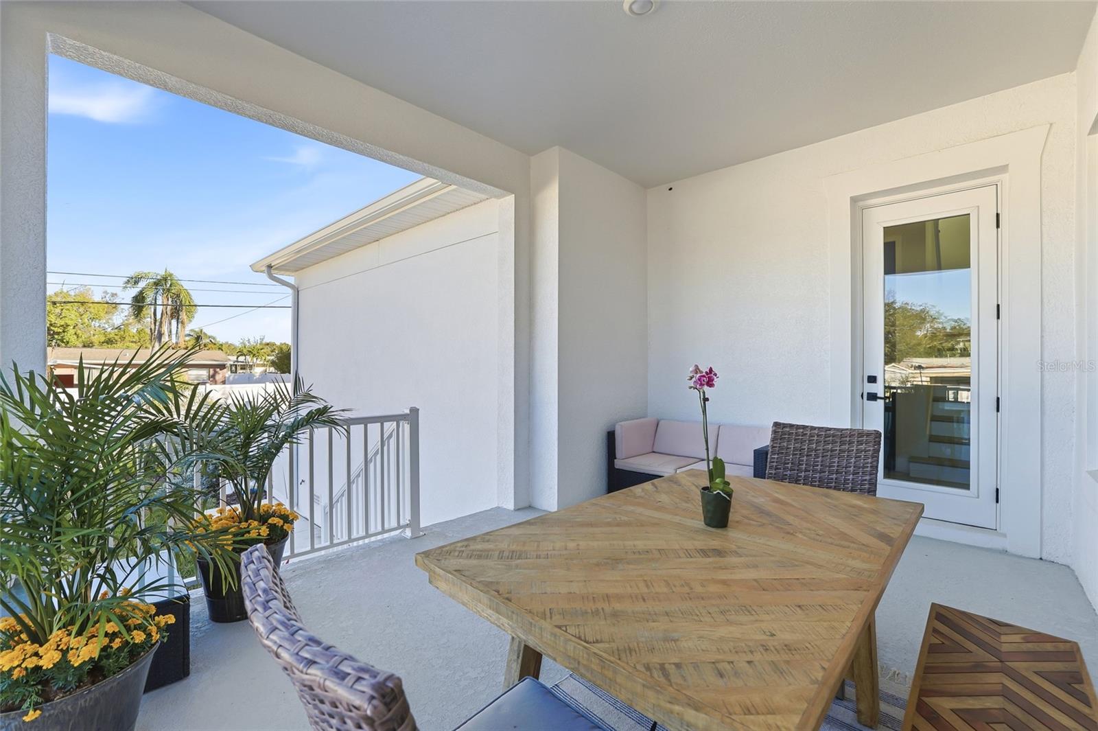 Rear porch overlooks the fenced back yard.