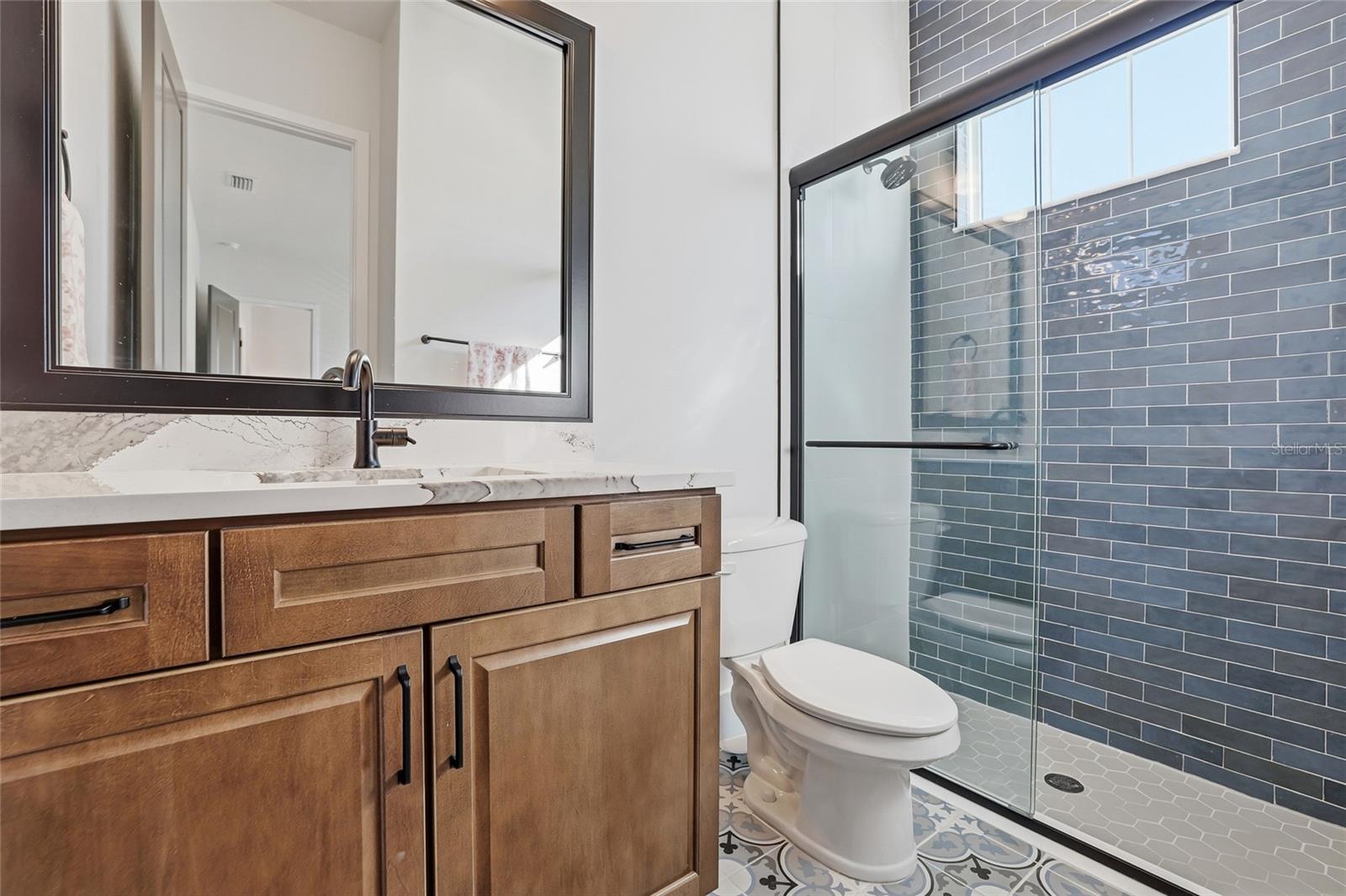 First floor full bathroom within a bedroom which could also be an office, studio or guest bedroom.