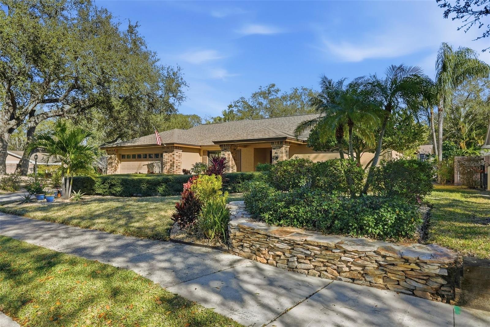 Home is surrounded by rock walls and low maintenance local plants.