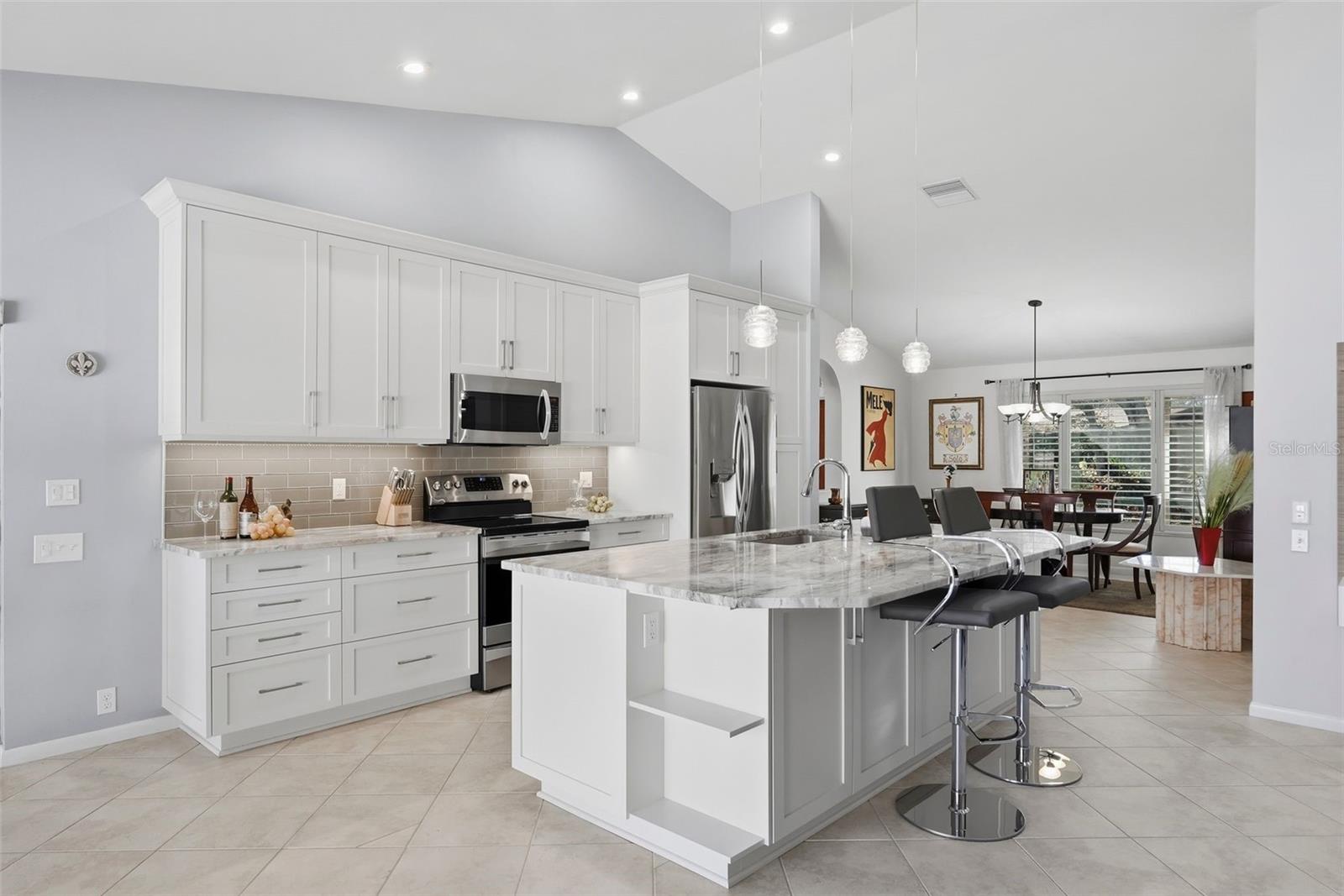 Kitchen with modern island that has sink and dishwasher.