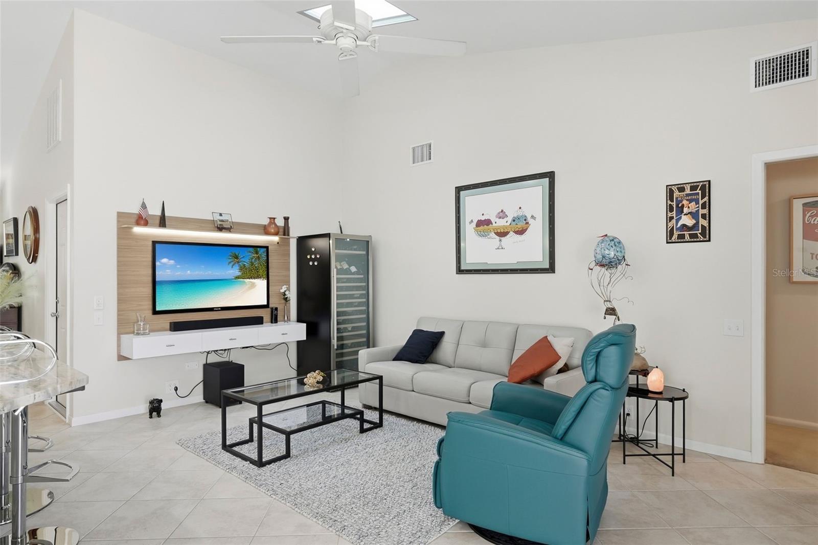 Leisure room next to the kitchen with floating wall mounted media center.  Flatscreen TV and sound bar is negotiable.