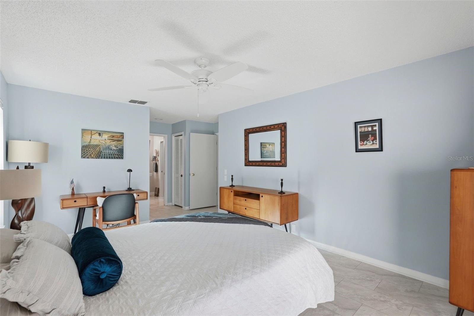 Primary bedroom with view into the bathroom and dual closets.