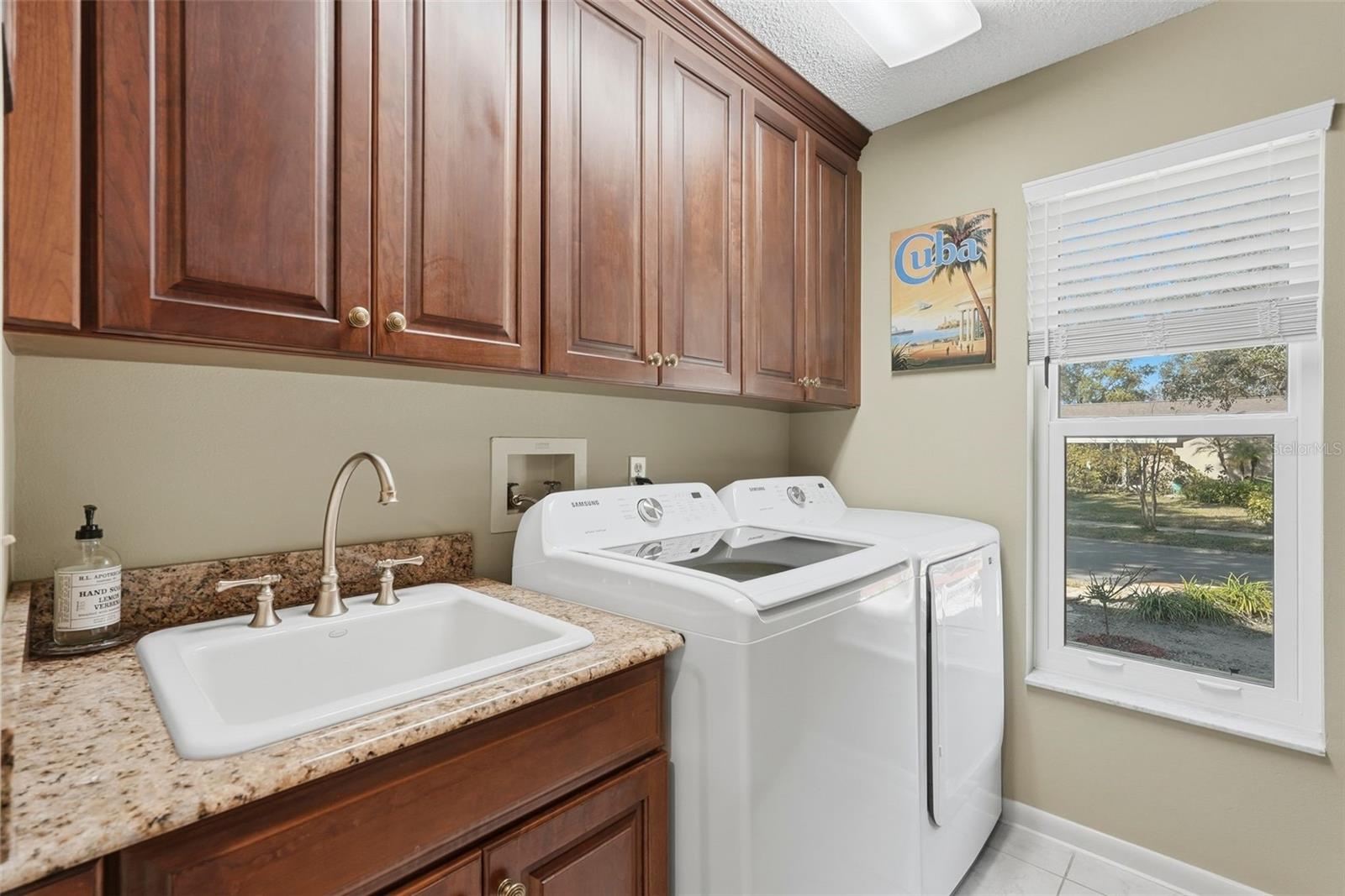 Indoor laundry area. Recently purchased Samsung Washer and dryer that do convey with the sale.