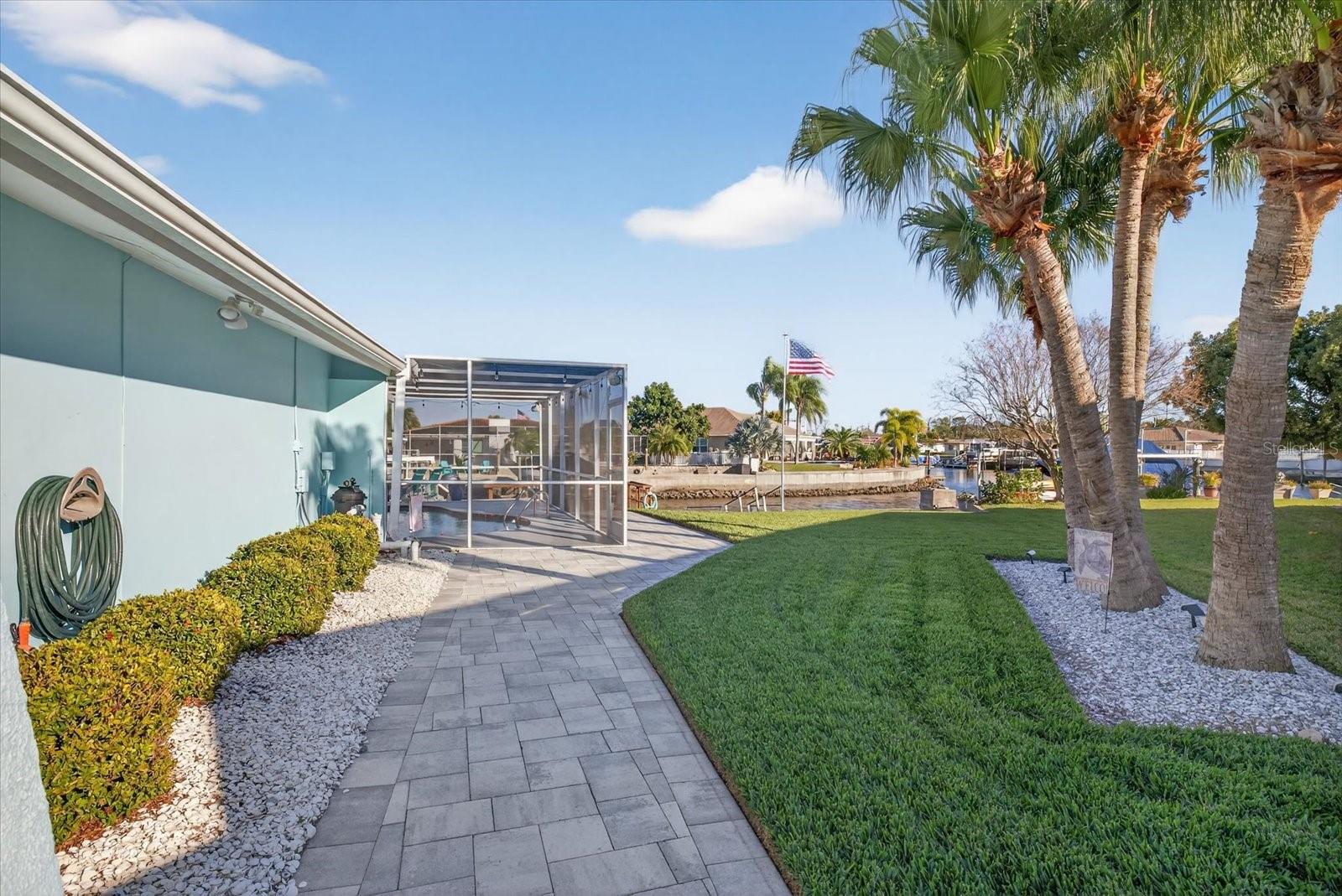 Side yard with paver path and mature landscaping