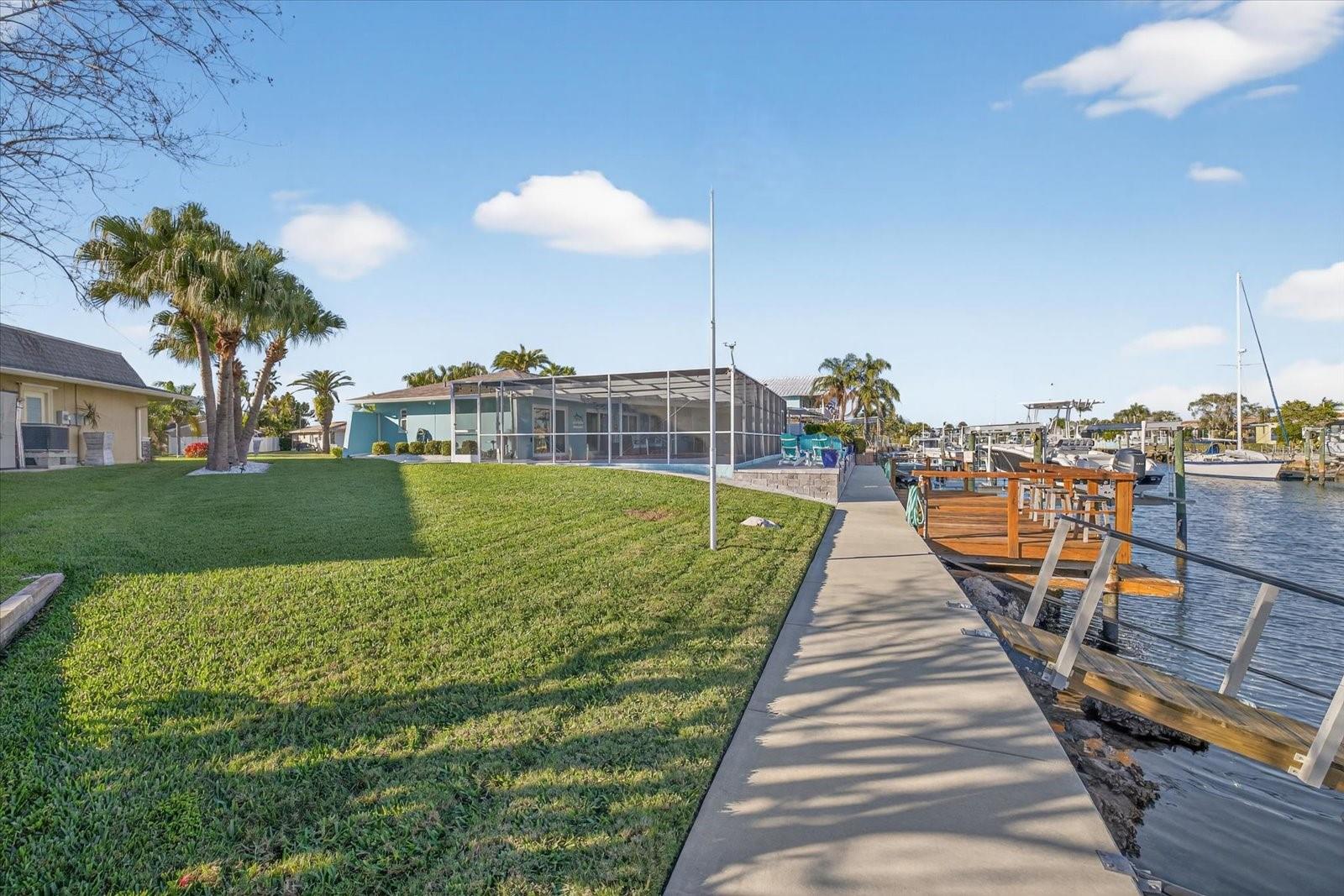 Spacious backyard with floating dock and stationary dock
