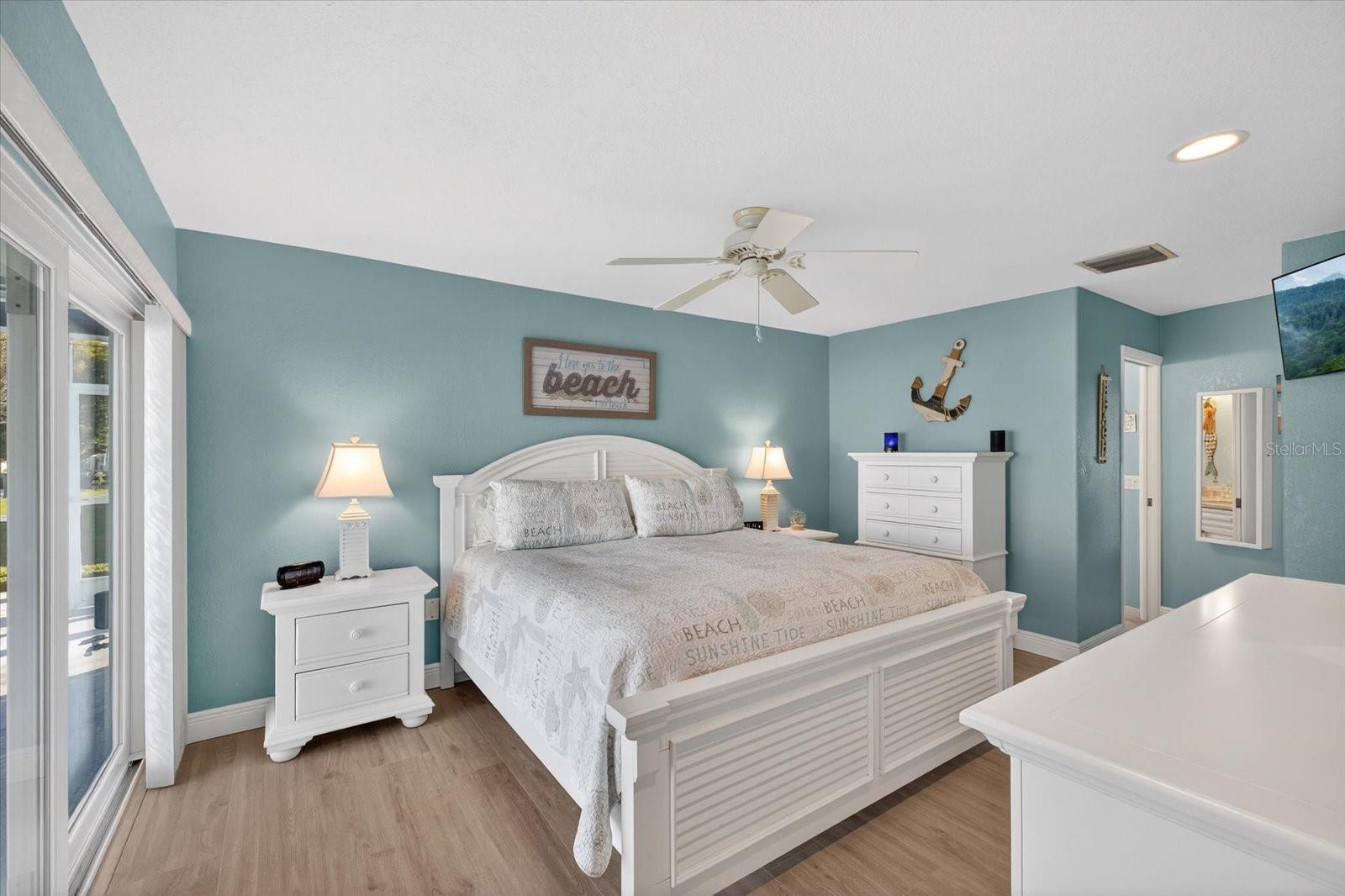 Primary suite overlooking pool and waterway