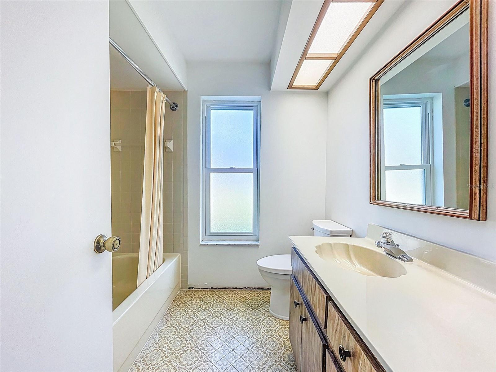 Hallway bath with tub.