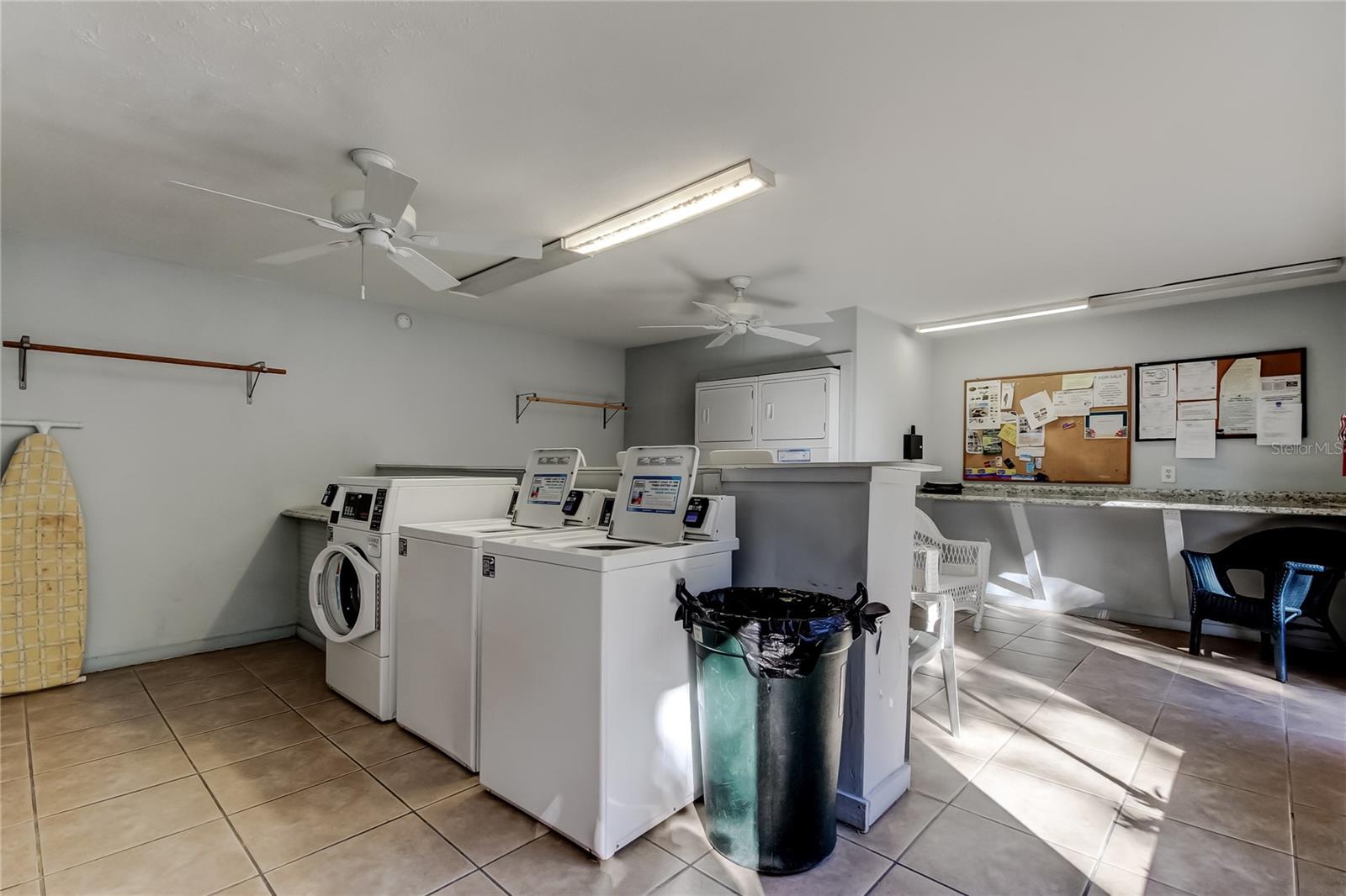 Complex laundry room adjacent to the back pool