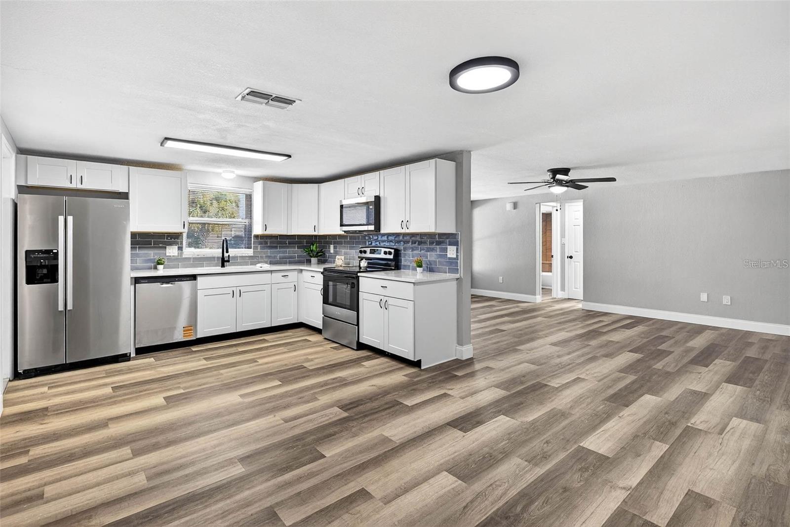 LIVING ROOM - DIDNING ROOM - KITCHEN AREA WITH ACCESS TO TWO BEDROOMS ON THE RIGHT