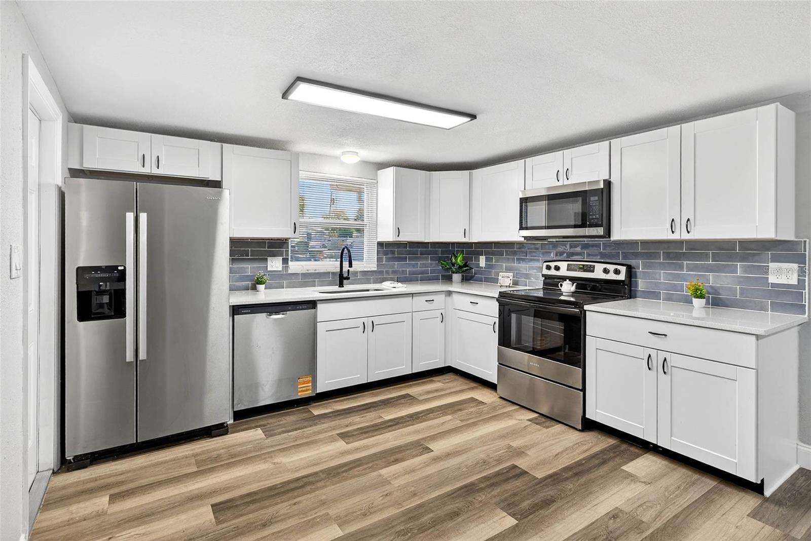 BRAND NEW SHAKER-STYLE CABINETS AND STAINLESS-STEEL APPLIANCES