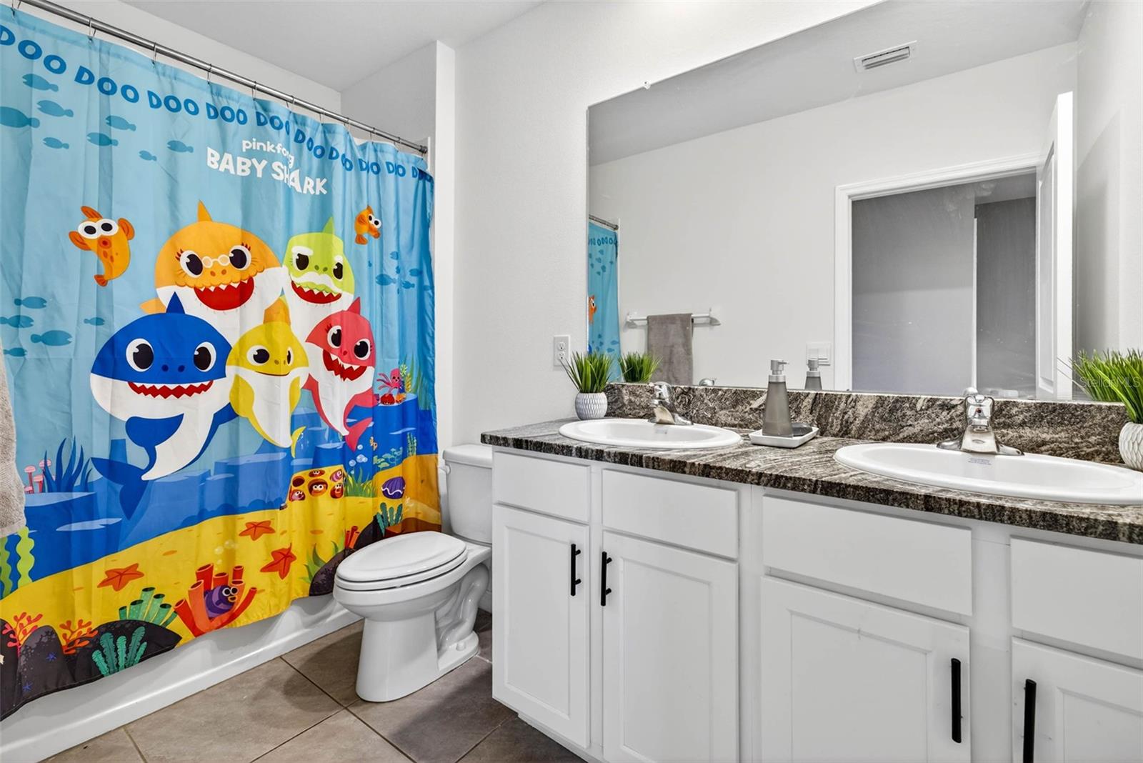 Bathroom 2, second floor with dual sinks + tub/shower.